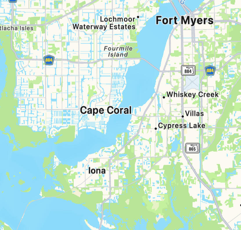 Floor to ceiling built-in library and media wall with LED lighting in Cape Coral home